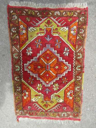 A small Middle Eastern mat with an orange central medallion ...