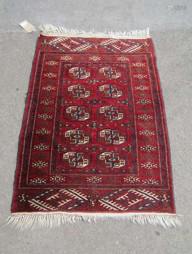 A Turkoman rug with a central panel of elephant foot gul on ...