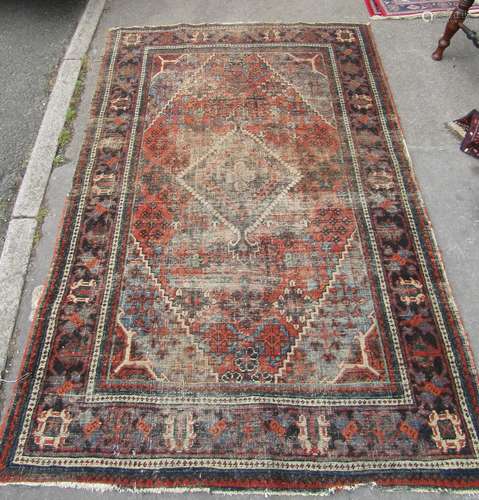 A faded early 20th century Djoshegan carpet with a central d...