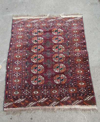 A Turkoman rug with two rows of elephant foot gul on purple ...