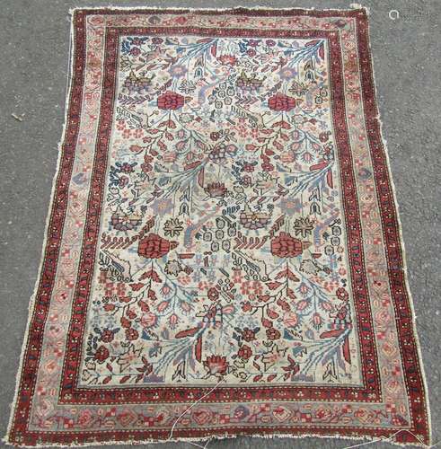 An old floral and bird decorated Persian rug, 140cm x 104cm.