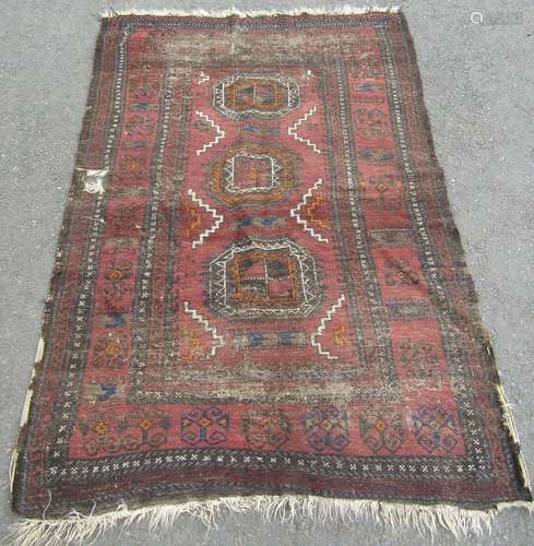 An old worn and faded Kazak rug, 180cm x 120cm.