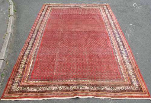 An old Afshar carpet with an overall field small botehs on a...