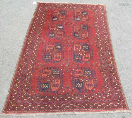 A Turkoman carpet with two rows of elephant foot gul on a re...