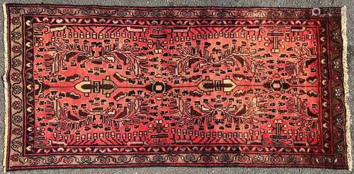 A Hamadan rug with a floral pattern on a rose pink ground. 1...