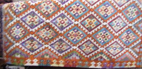 A Chobi kilim with an overall bright coloured geometric patt...