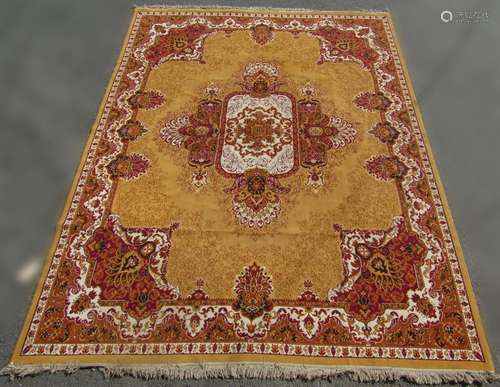 A large Persian style carpet with a central floral medallion...