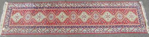 A Middle Eastern designed runner with single row of interloc...