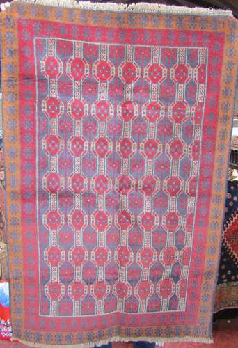 A Baluchi rug with a new thick pile with an all over red and...