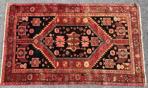 A Zanjan rug with a central geometric motif with radiating s...