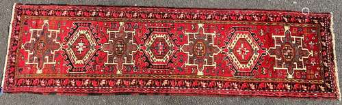 A Heriz runner with a single row interlocking shaped medalli...