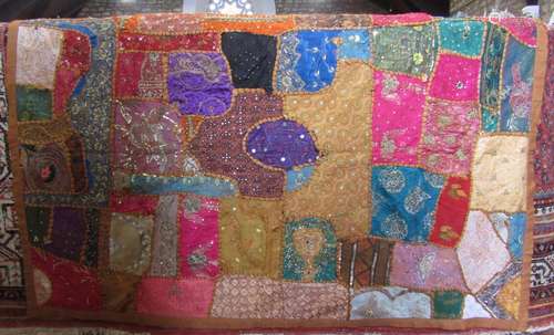 A Pakistani bright silk, sequinned and embroidered wall hang...