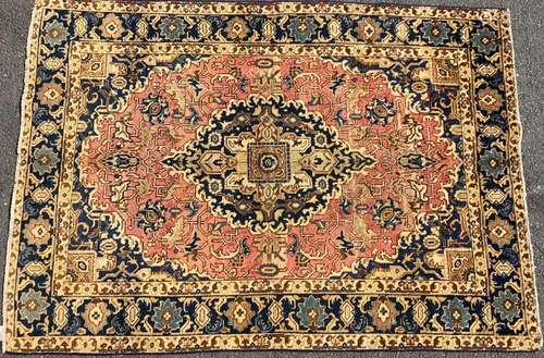 A Tabriz rug with a large central medallion surrounded by a ...