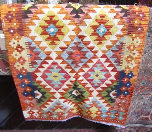 A Chobi kilim runner with an overall bright geometric patter...