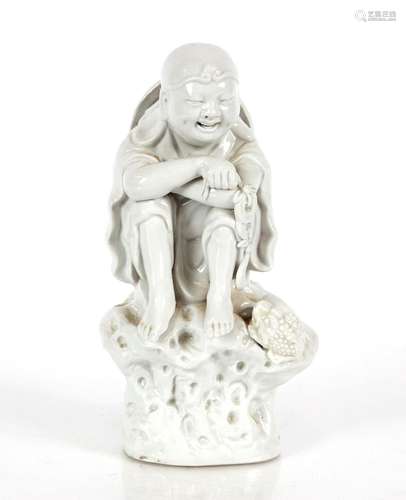 A Chinese blanc de chine group of a young boy and mythical c...