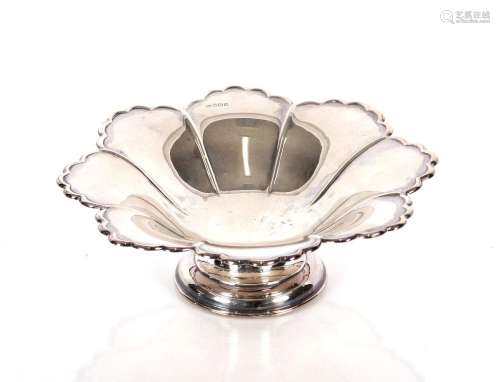 An Edwardian silver pedestal dish, with shaped segment borde...