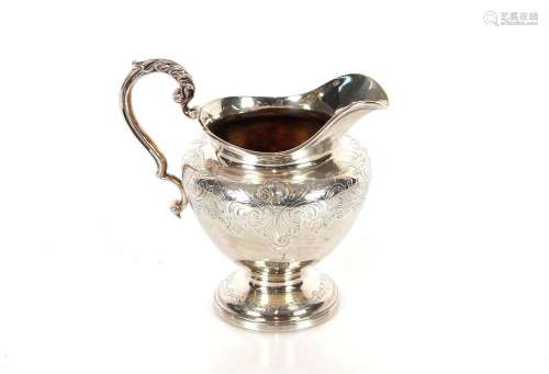 A Victorian silver baluster cream jug, with foliate engraved...