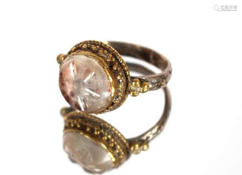 An antique Seljuk white metal and stone mounted finger ring