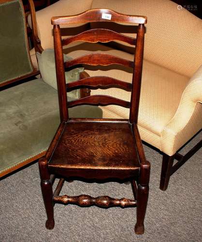 A 19th Century elm ladder back side chair, having solid seat...