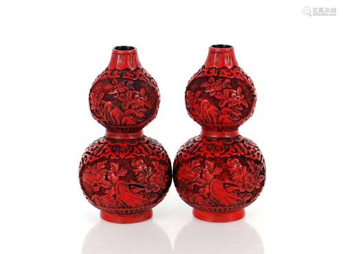 A pair of cinnabar lacquered style double gourd shaped vases...