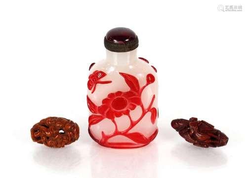 A Beijing glass red and white overlaid snuff bottle; and two...