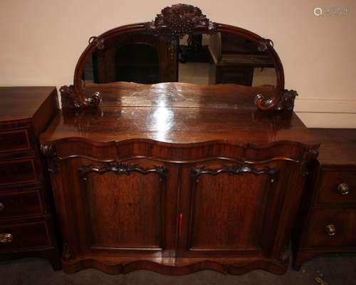 A Victorian rosewood chiffonier, of serpentine shape, the mi...