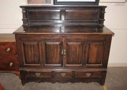 An early 20th Century, oak sideboard, with raised panel back...