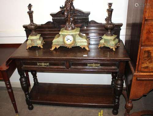 An early 20th Century oak serving table, having raised shape...