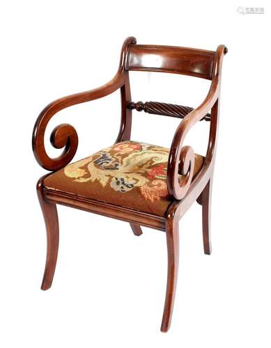 A 19th Century mahogany elbow chair, having rectangular tabl...