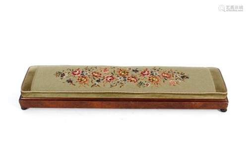 A Victorian walnut long footstool, with needlepoint upholste...