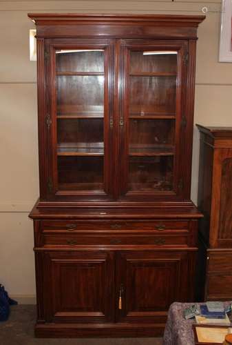 A late Victorian mahogany bookcase, the upper section with a...