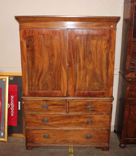 A 19th Century mahogany linen press, the upper section fitte...