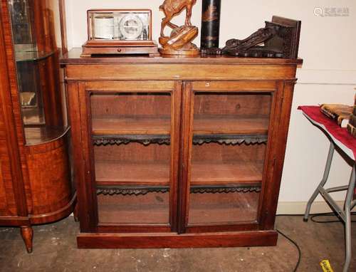 A Victorian mahogany bookcase, the adjustable shelves enclos...