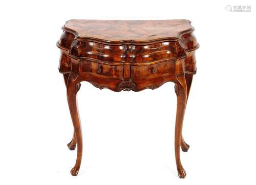 A 18th Century walnut side table of serpentine shape, the bo...