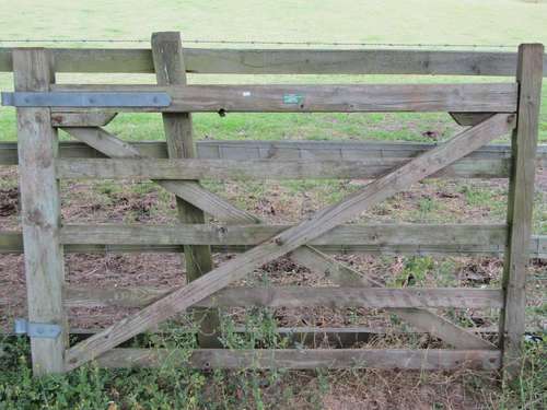 A weathered softwood five bar paddock gate with galvanised h...