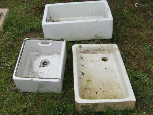 Three reclaimed white glazed butlers sinks of varying size a...