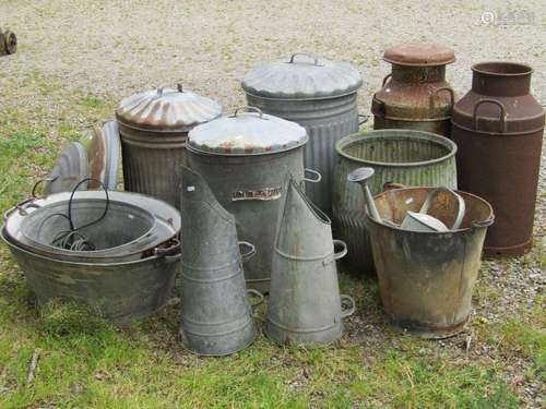 Two vintage weathered heavy gauge milk churns together with ...