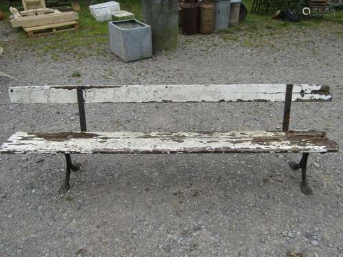 An old platform bench with painted and weathered wooden plan...