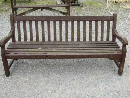 A vintage substantial stained hardwood garden bench with sla...