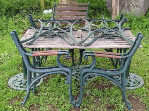 A suite of garden furniture with matt green painted finish a...