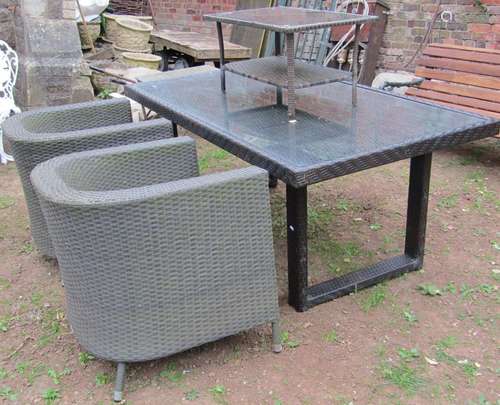 A collection of rattan garden furniture comprising table of ...