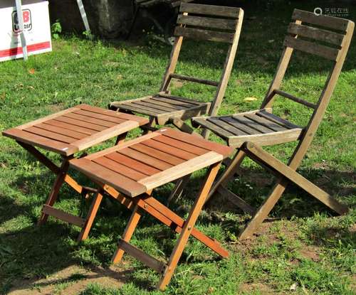 A pair of weathered hardwood folding garden chairs with slat...