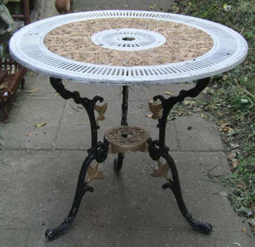 A painted cast aluminium garden terrace table with decorativ...