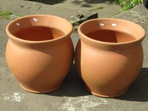 A pair of contemporary terracotta oviform garden planters 40...