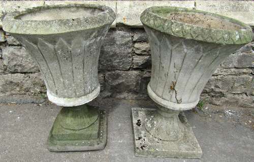 Two similar weathered cast composition stone garden urns of ...