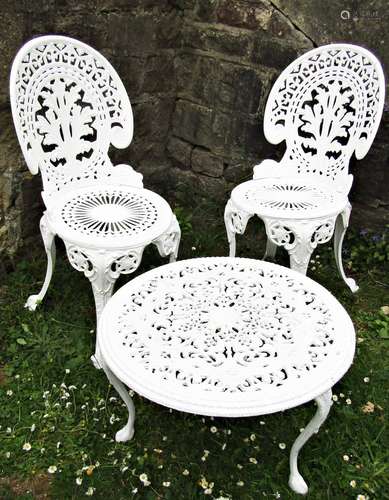 A pair of white painted cast aluminium garden chairs with de...