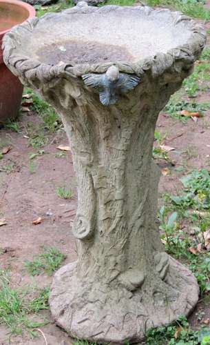 A novelty weathered cast composition stone bird bath in the ...