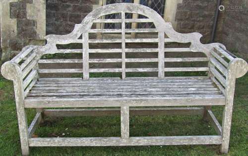 A weathered hardwood Lutyens style garden bench 166 cm long