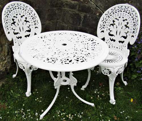 A cream painted cast aluminium garden terrace table of circu...