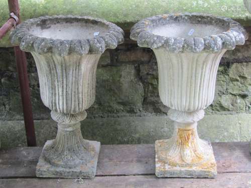 A pair of weathered cast composition stone trumpet shaped ga...